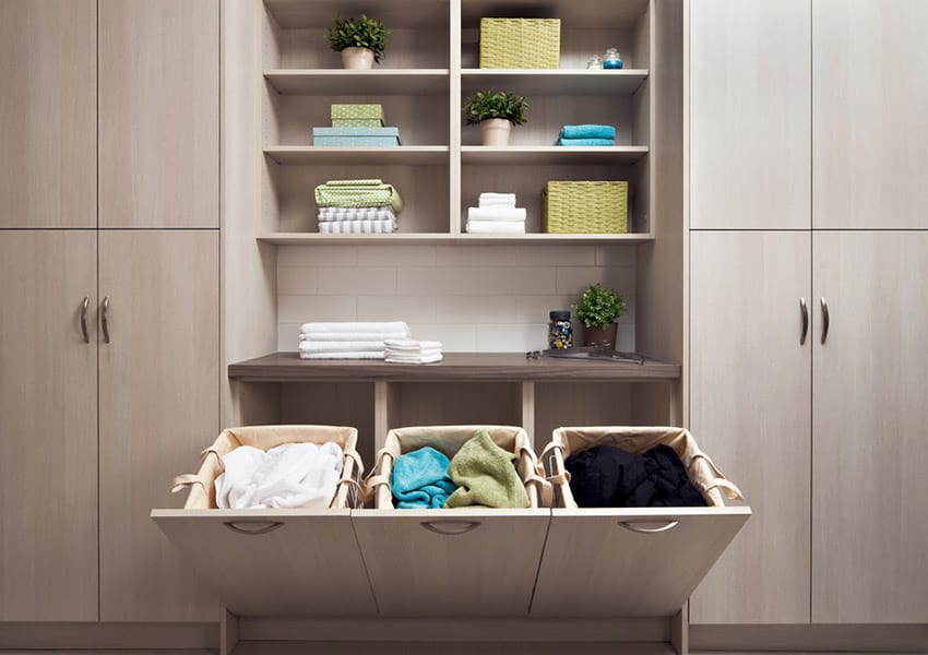 built-in laundry room hampers by Organized Interiors
