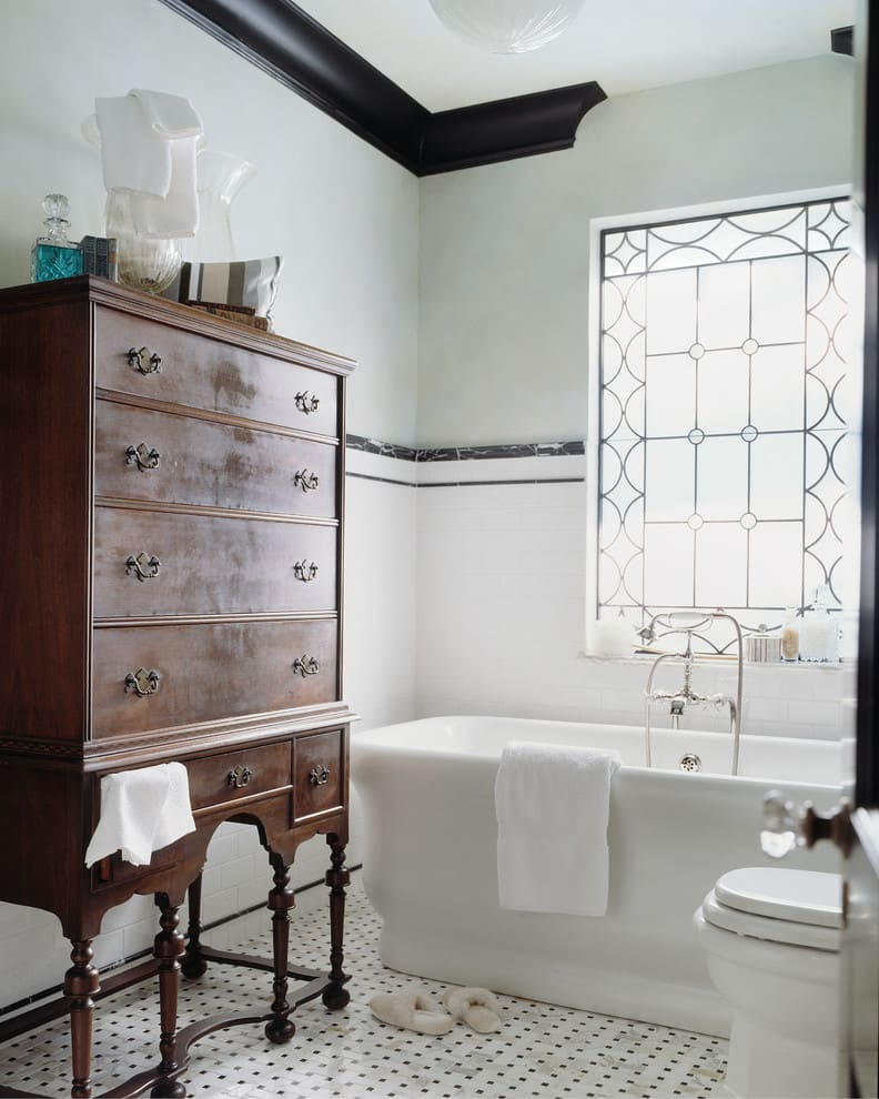 Victorian style bathroom with basketweave marble tile floor and a pedestal tub